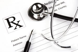 A Stethoscope over a medical report form.