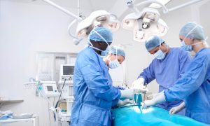 Meidcal surgeons performing surgery in an operating theatre together - Copyspace