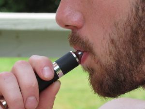closeup of man smoking e-cigarette